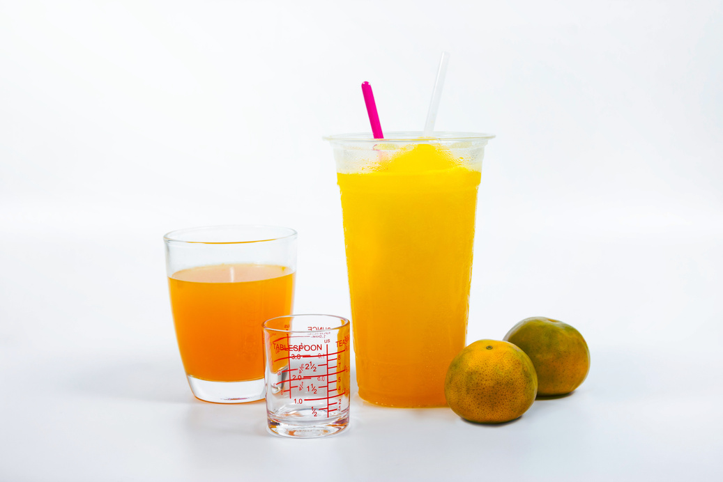 Slush ice with orange in Plastic Cup white background.